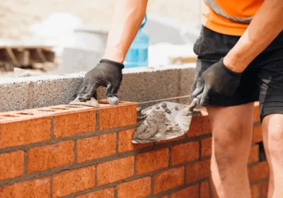 construction-worker-using-trowel-lay-600nw-2475346485